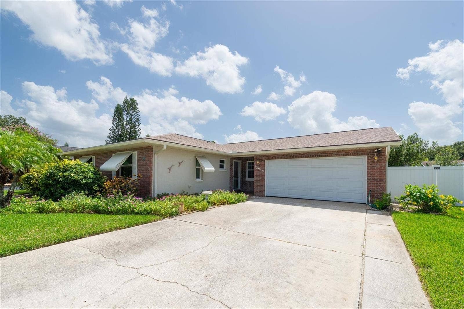 12939 115TH STREET, Largo, FL 33778 Front of the home with large driveway