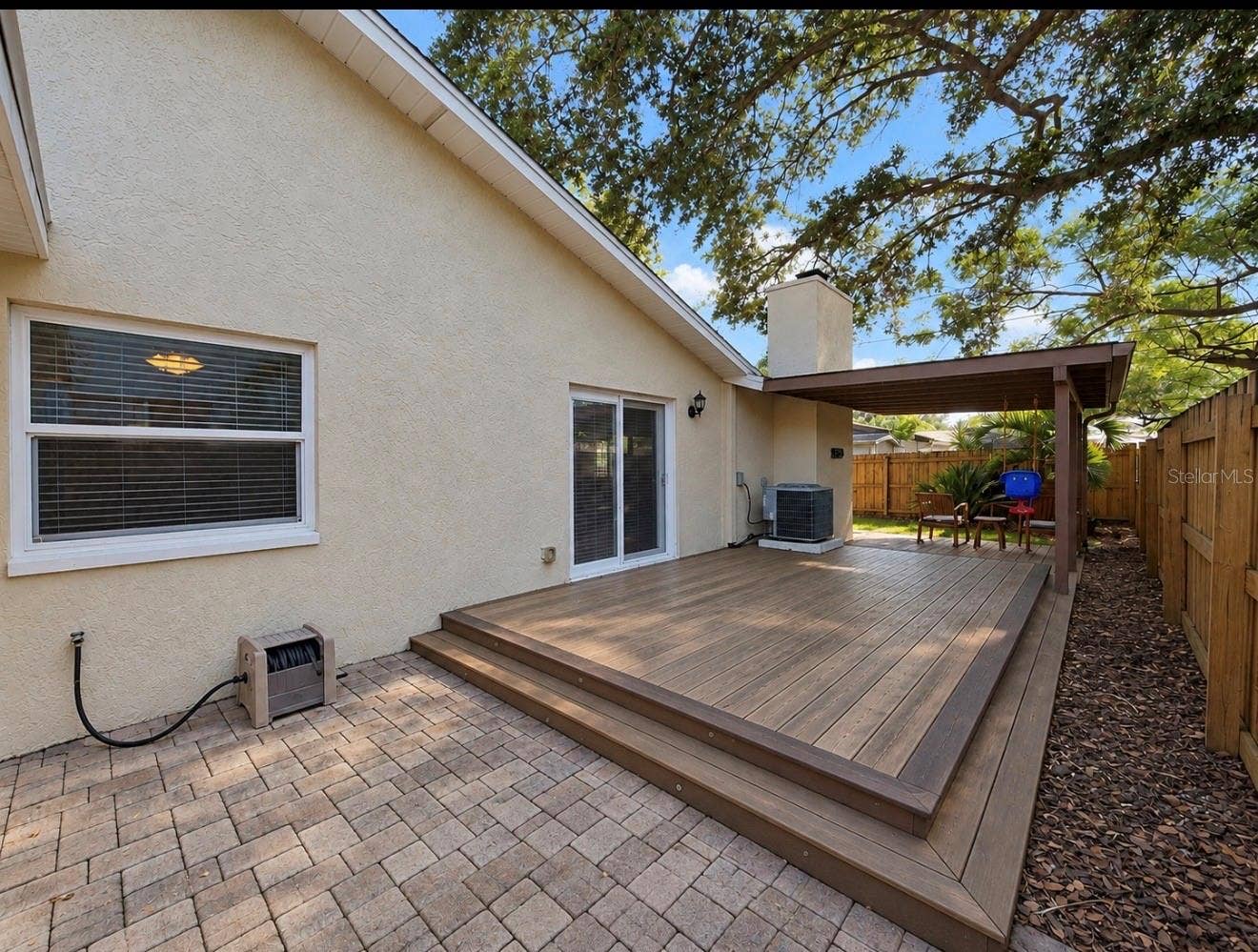 1231 ROSEWOOD STREET, Largo, FL 33770 paver side of home with entertainment deck