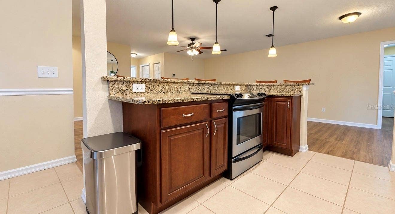 1231 ROSEWOOD STREET, Largo, FL 33770 island in kitchen with granite counters