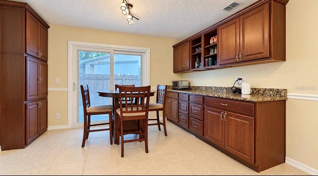 1231 ROSEWOOD STREET, Largo, FL 33770 dining area with built in bar area