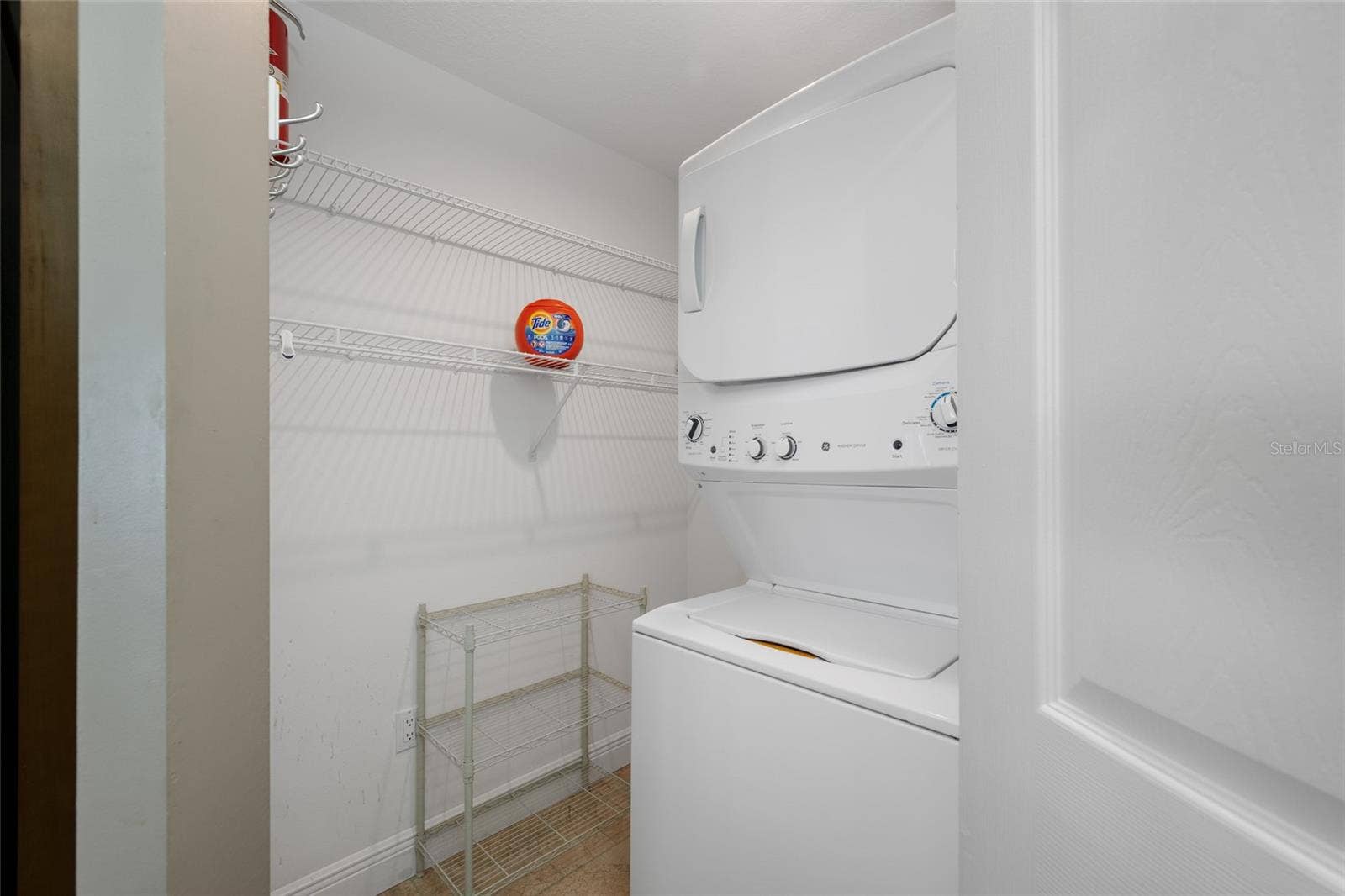 Laundry/Storage Room with Stack Washer and Dryer.