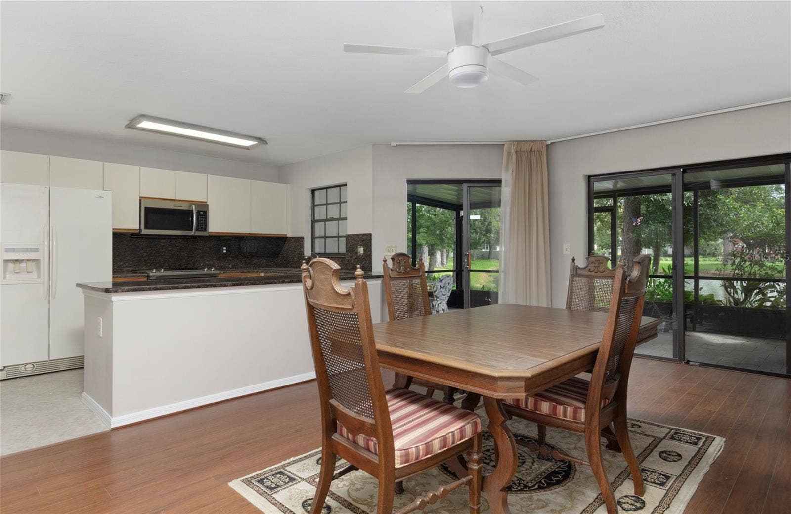 1210 HOUNDS RUN, Safety Harbor, FL 34695 Dining room opens to porch and kitchen.