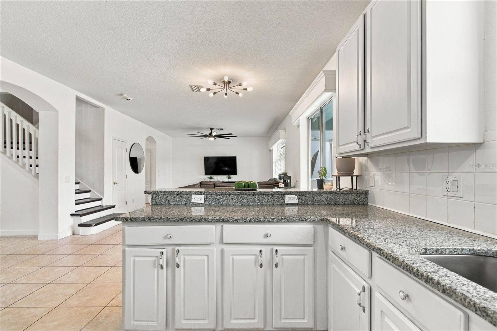 Your kitchen overlooks for expansive family room and pool areas.