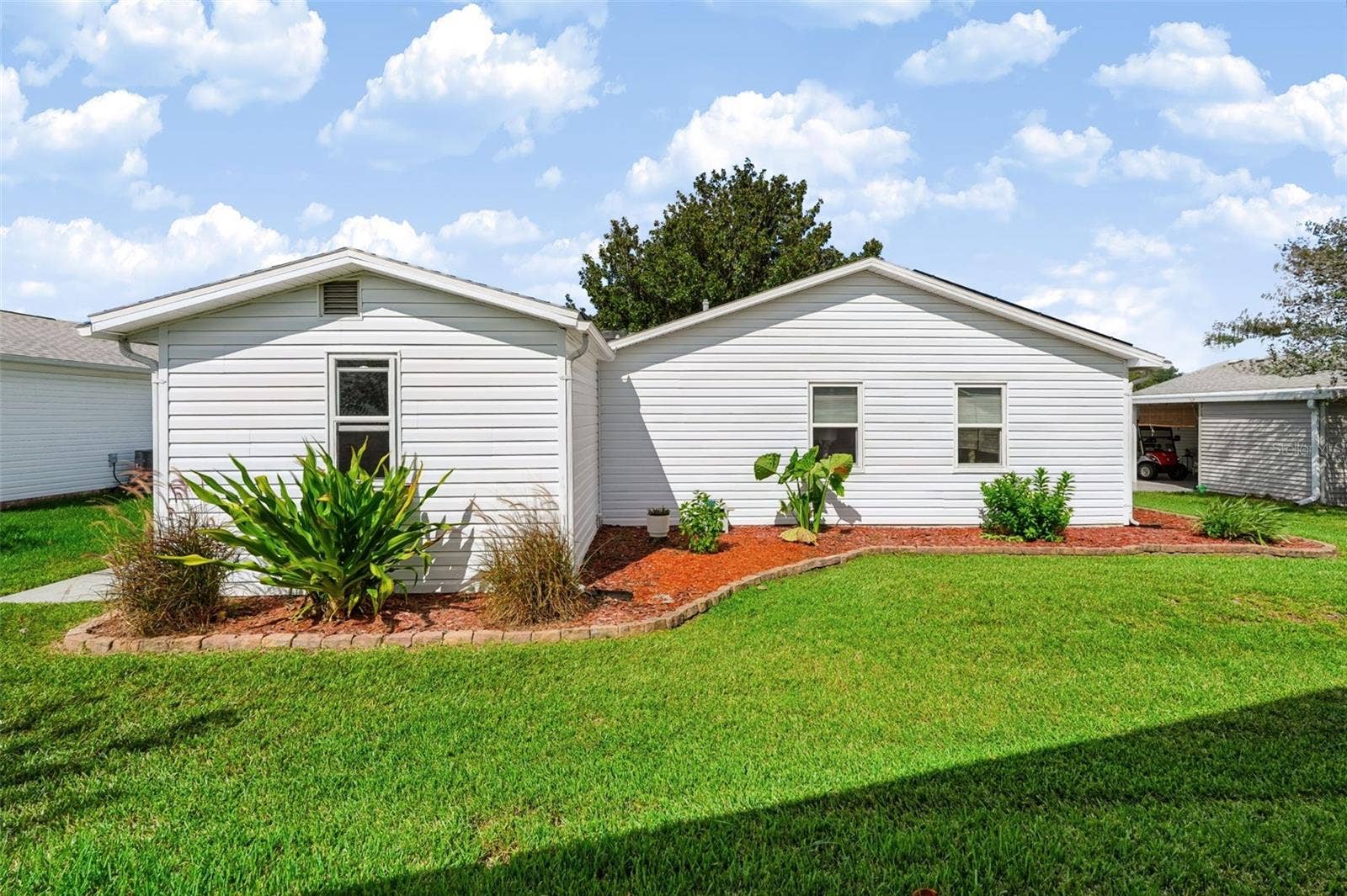 1220 MARIA COURT, Lady Lake, FL 32159 Backside of home with landscaping