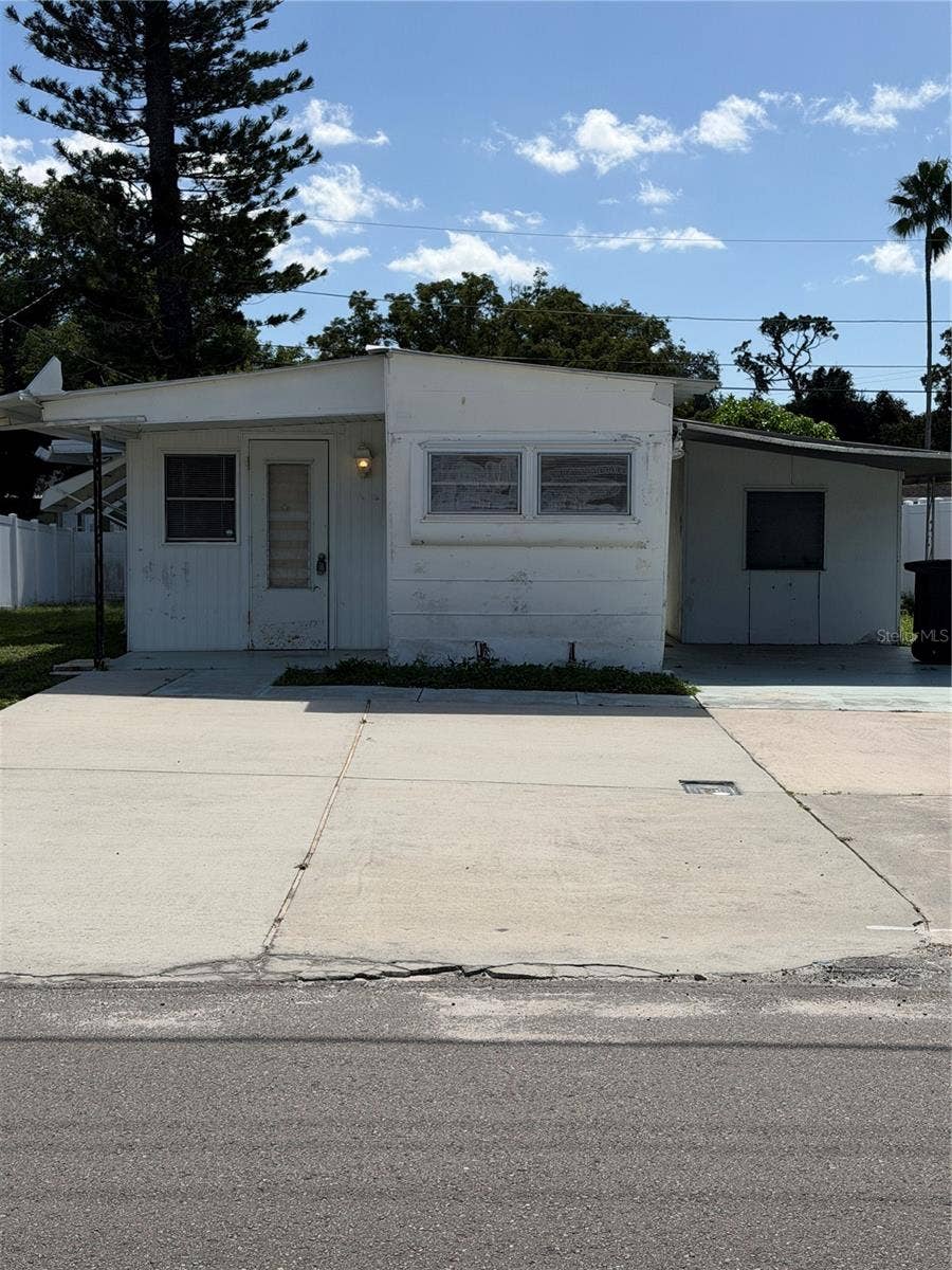 4120 BUENA VISTA LANE, Holiday, FL 34691 Mobile home with added on sides, carport and large parking pad.