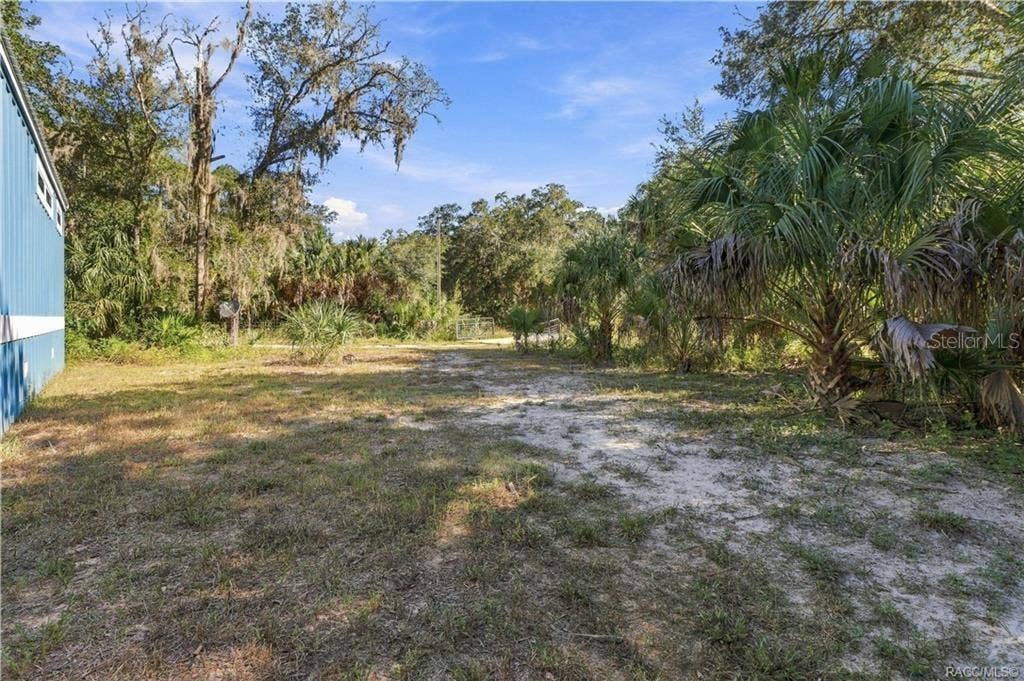 7528 N CHABAUD TERRACE, Crystal River, FL 34428 BRING YOUR TOYS & ENJOY THE SPACE! The 1.42-ACRE FULLY FENCED PROPERTY offers open areas, mature trees, Florida palms & a gated entrance.
