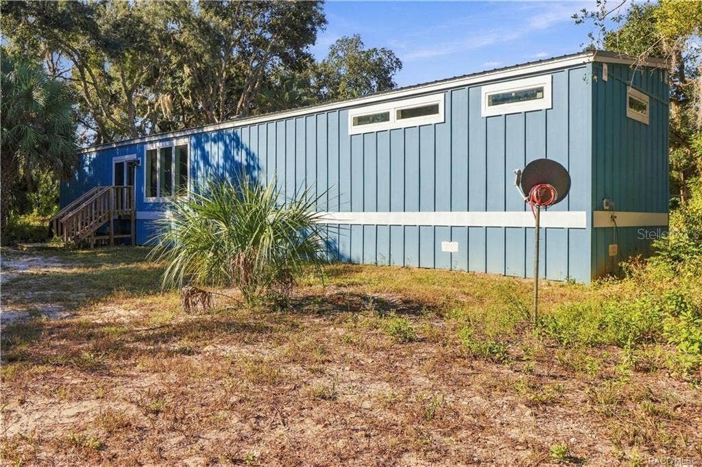 7528 N CHABAUD TERRACE, Crystal River, FL 34428 A LITTLE BIT COUNTRY, A LOT TO LOVE! The home's attractive BLUE EXTERIOR, WHITE TRIM & METAL ROOF complement the surrounding natural Florida landscape.