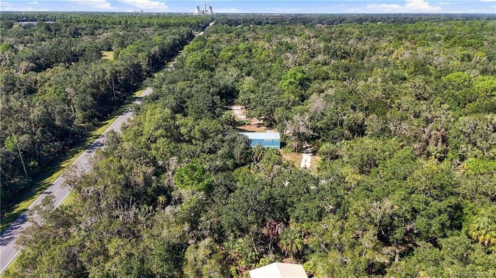 7528 N CHABAUD TERRACE, Crystal River, FL 34428 SURROUNDED BY NATURE! This expansive aerial view captures the home tucked among beautiful trees & the wooded character of the surrounding area.