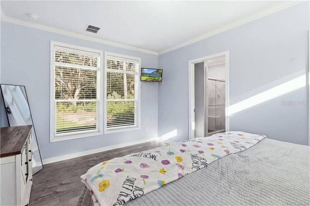 7528 N CHABAUD TERRACE, Crystal River, FL 34428 BRIGHT & RELAXING PRIMARY SUITE! Large windows overlook the natural surroundings, while the adjoining PRIVATE BATH offers a convenient WALK-IN SHOWER.