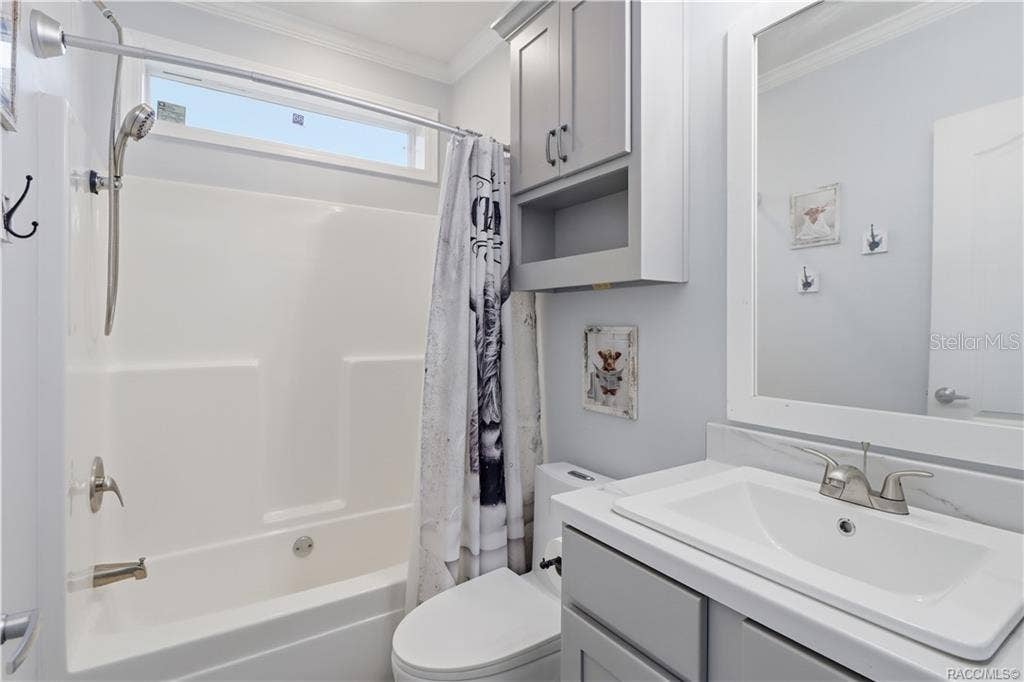 7528 N CHABAUD TERRACE, Crystal River, FL 34428 STYLE & EVERYDAY CONVENIENCE! The SECOND FULL BATHROOM features a GRAY VANITY, framed mirror, additional wall cabinetry & a TUB/SHOWER COMBINATION.