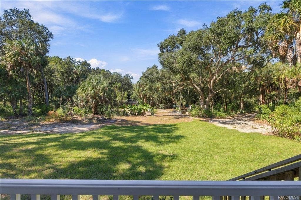 7528 N CHABAUD TERRACE, Crystal River, FL 34428 NATURE RIGHT OUTSIDE YOUR DOOR! Enjoy views of the expansive lawn, mature trees & Florida palms from the comfort of your front porch.