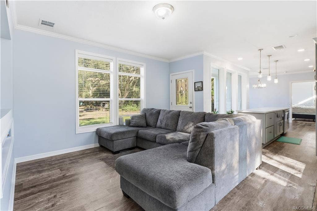 7528 N CHABAUD TERRACE, Crystal River, FL 34428 RELAX & MAKE YOURSELF COMFORTABLE! The spacious LIVING ROOM features attractive flooring, abundant natural light & an open connection to the kitchen.