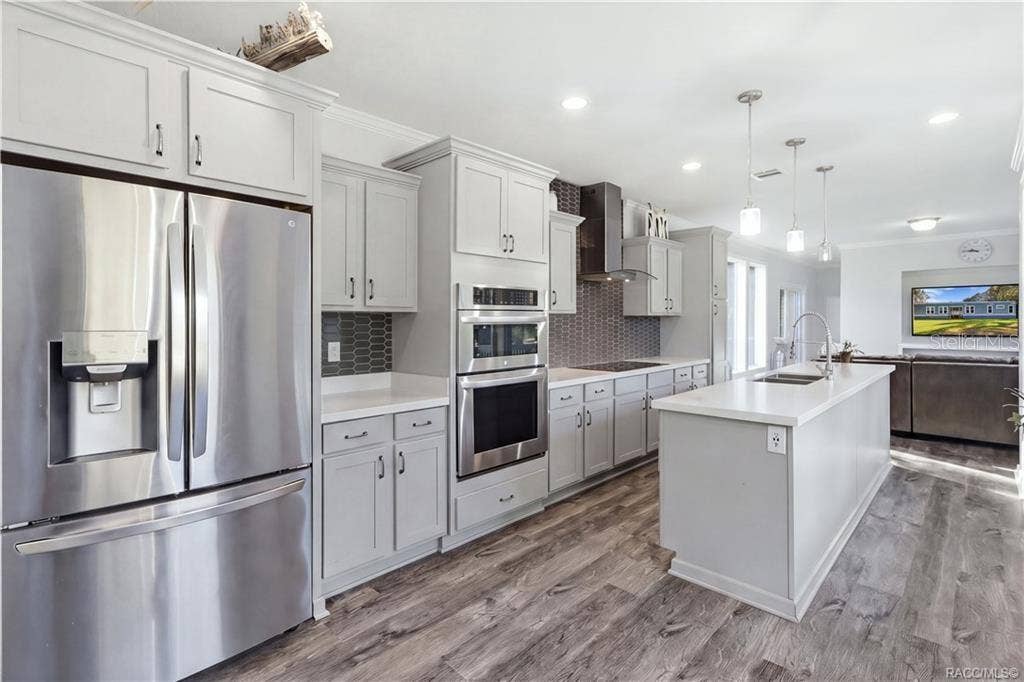 7528 N CHABAUD TERRACE, Crystal River, FL 34428 STYLE MEETS FUNCTION! The thoughtfully designed kitchen features GRAY CABINETRY, a DOUBLE-BASIN SINK, sleek spring-style faucet & large windows overlooking the beautiful outdoors.