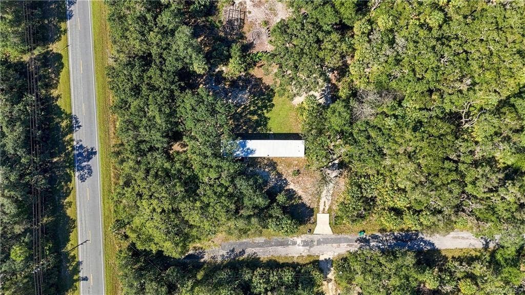 7528 N CHABAUD TERRACE, Crystal River, FL 34428 ROOM TO ENJOY THE OUTDOORS! This overhead aerial view highlights the home's setting among mature trees, open yard space & surrounding greenery.
