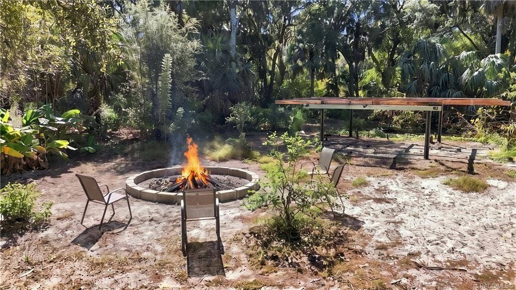 7528 N CHABAUD TERRACE, Crystal River, FL 34428 GATHER AROUND THE FIRE! A circular FIRE PIT AREA surrounded by seating offers an inviting spot for evening conversations, roasting marshmallows & enjoying the outdoors.
