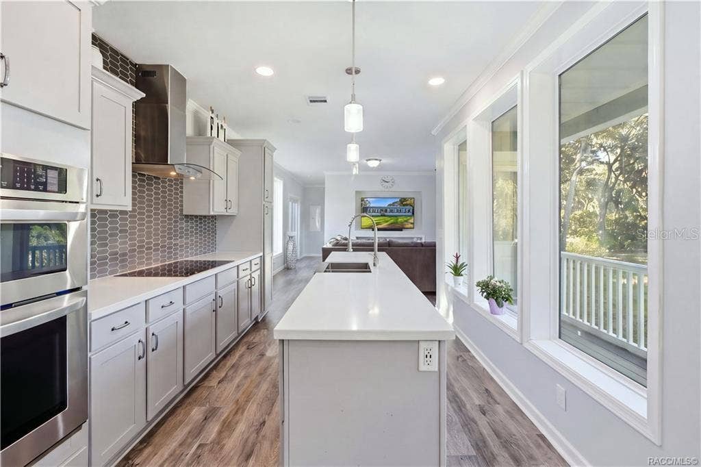 7528 N CHABAUD TERRACE, Crystal River, FL 34428 THE KITCHEN IS THE SHOWSTOPPER! Beautiful GRAY CABINETRY, expansive countertops, a generous CENTER ISLAND, stainless steel appliances & pendant lighting create an impressive gathering space.