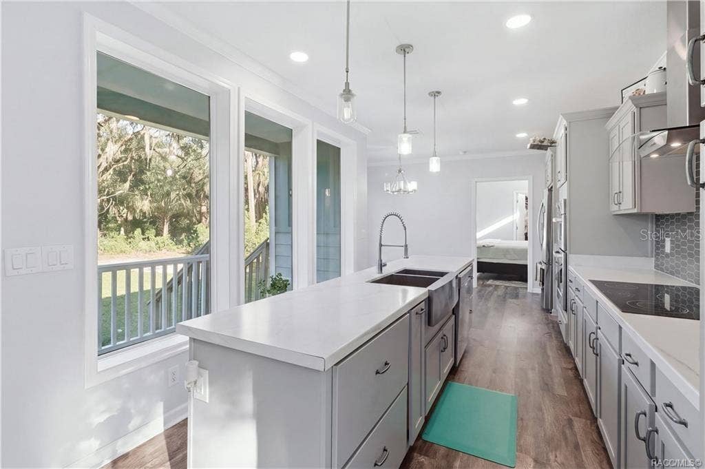 7528 N CHABAUD TERRACE, Crystal River, FL 34428 A KITCHEN W/A VIEW! The impressive island offers generous workspace, while large windows bring in natural light & showcase the surrounding greenery.