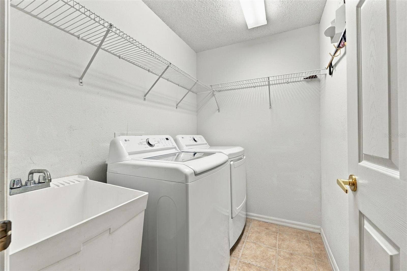 1149 WOLFORD DRIVE, New Port Richey, FL 34655 Indoor laundry area with sink and storage