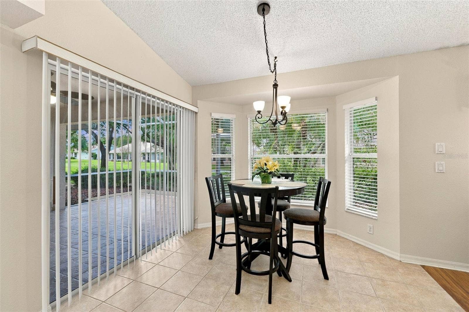 1149 WOLFORD DRIVE, New Port Richey, FL 34655 Eat in nook with bay window and a sliding door out to the screened-in lanai