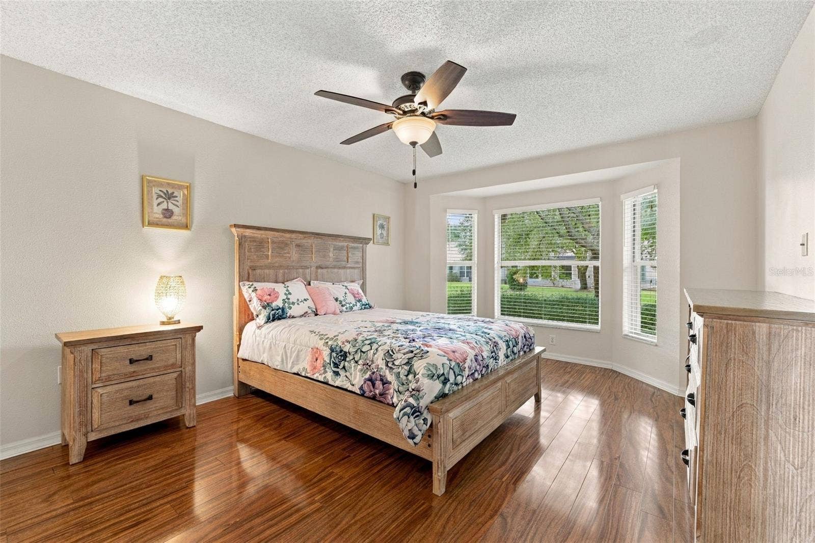 1149 WOLFORD DRIVE, New Port Richey, FL 34655 Primary Bedroom with a bay window, ceiling fan and laminate flooring