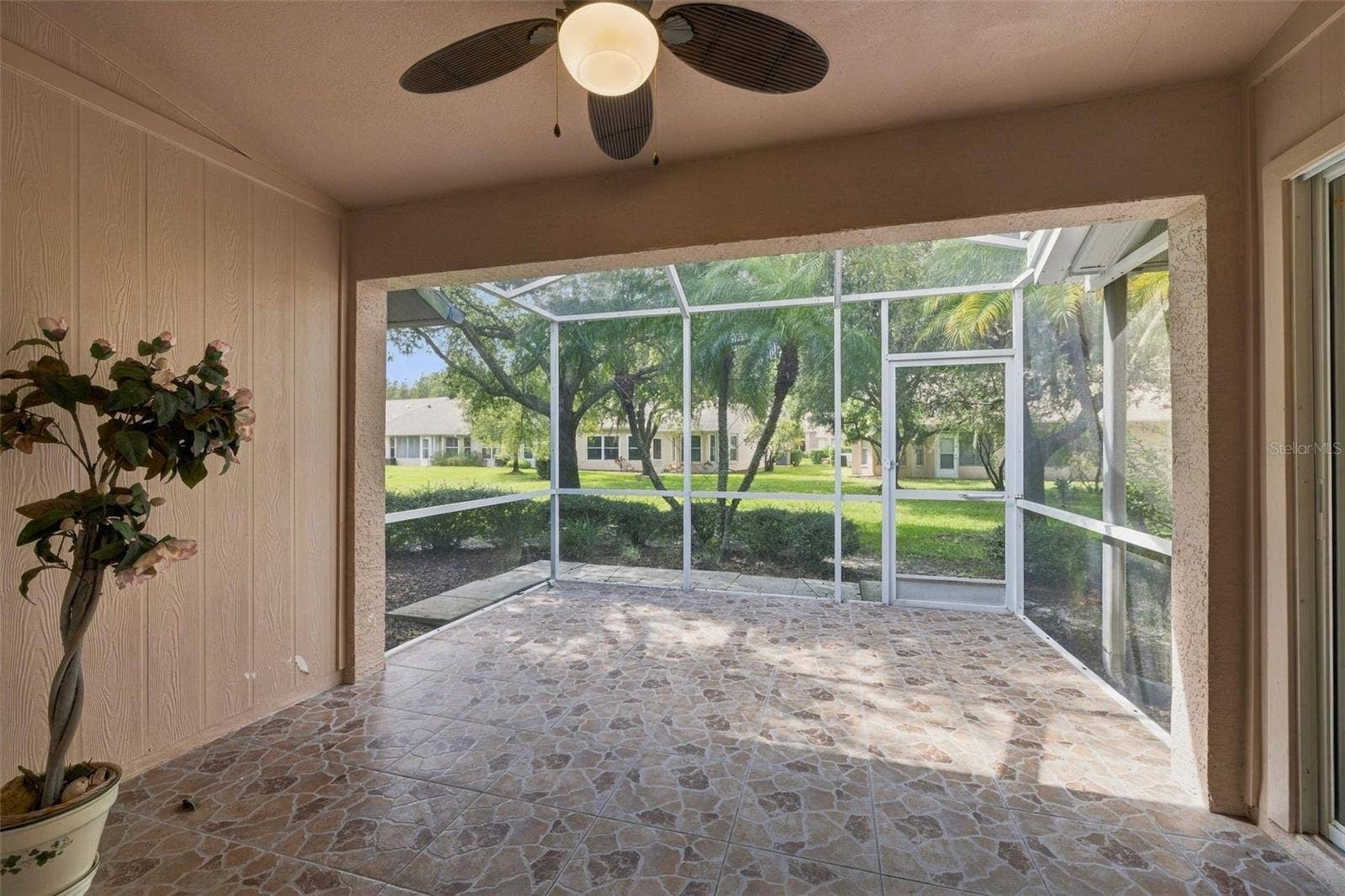 1149 WOLFORD DRIVE, New Port Richey, FL 34655 Tiled and screened-in lanai, accessed through the dining room or kitchen area