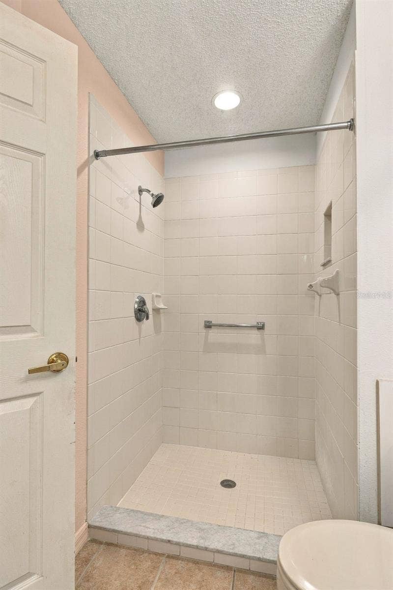 1149 WOLFORD DRIVE, New Port Richey, FL 34655 Ensuite features a walk-in shower