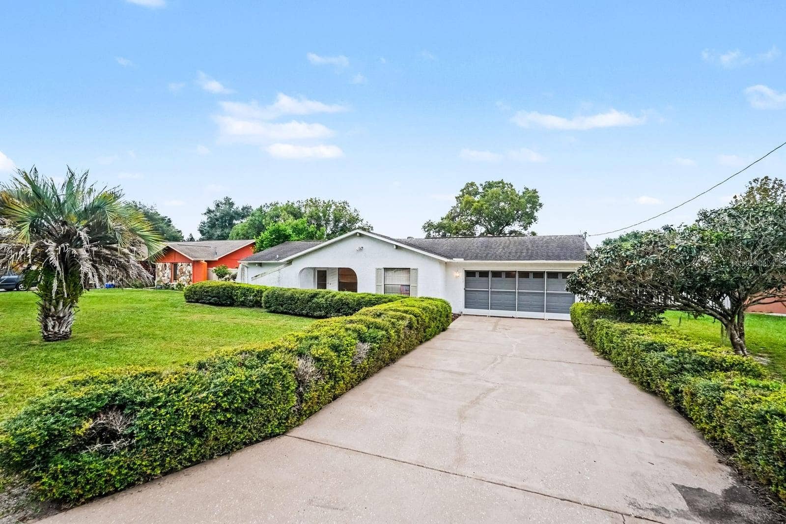 Wide Driveway Leads to Attached Two-Car Garage and Entry
