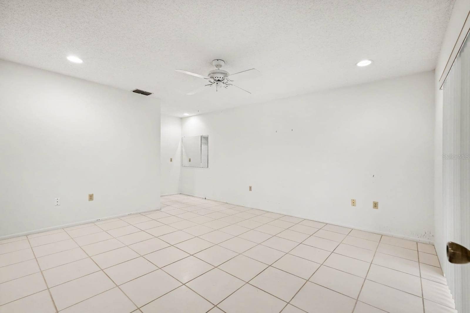 Spacious Secondary Bedroom with Tile Flooring and Multiple Electrical Outlets