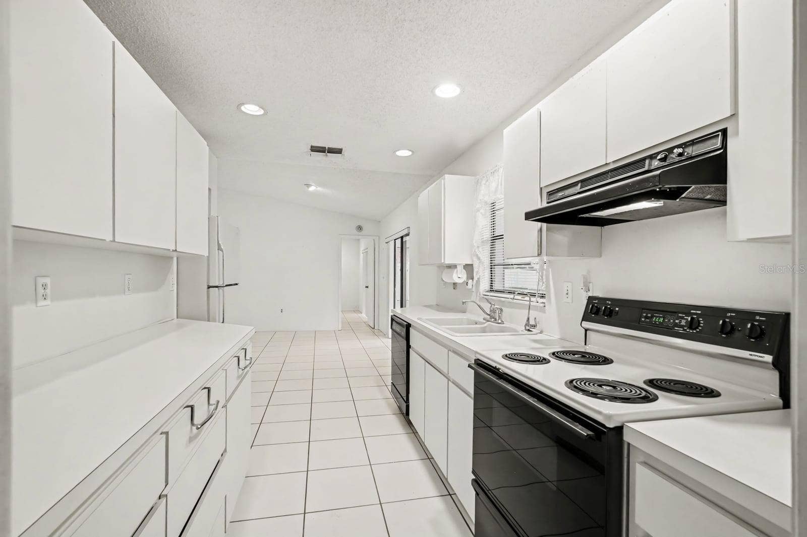Kitchen Features Electric Range, Refrigerator & Abundant Counter Space