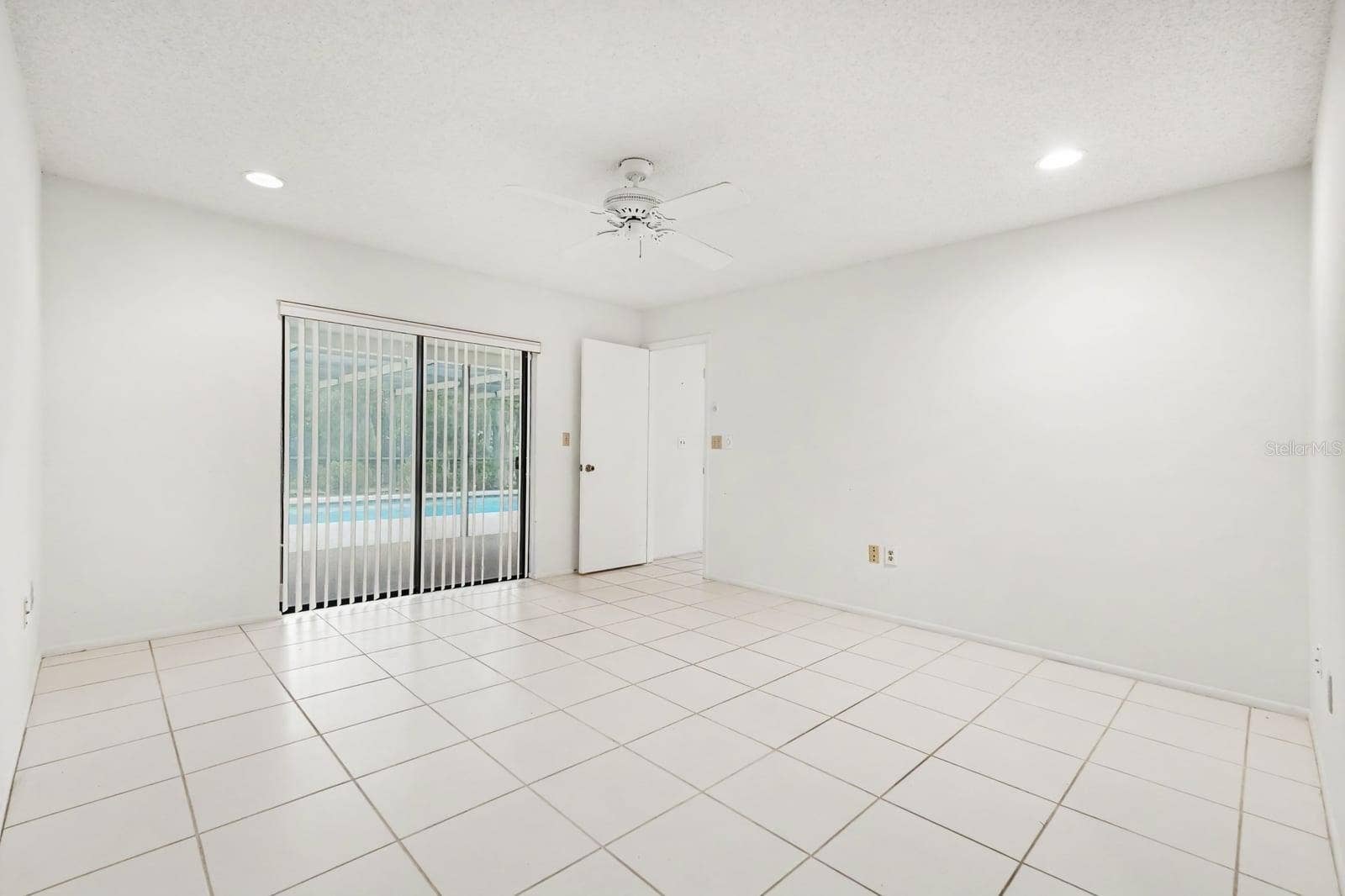 Spacious Room with Sliding Glass Doors to Pool and Patio Area