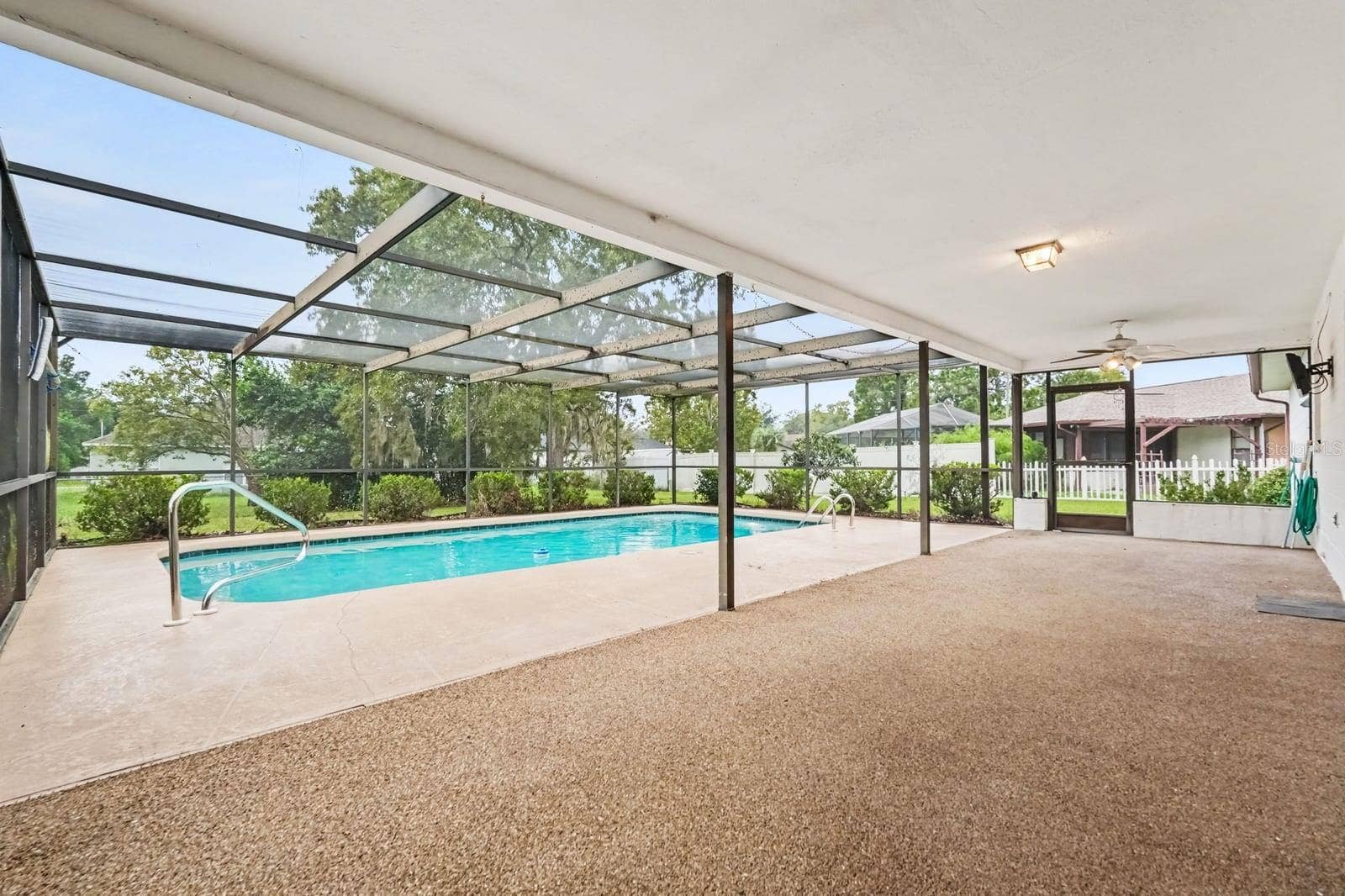 Covered Pool with Screened Enclosure, Clean Water, and Shade Structure