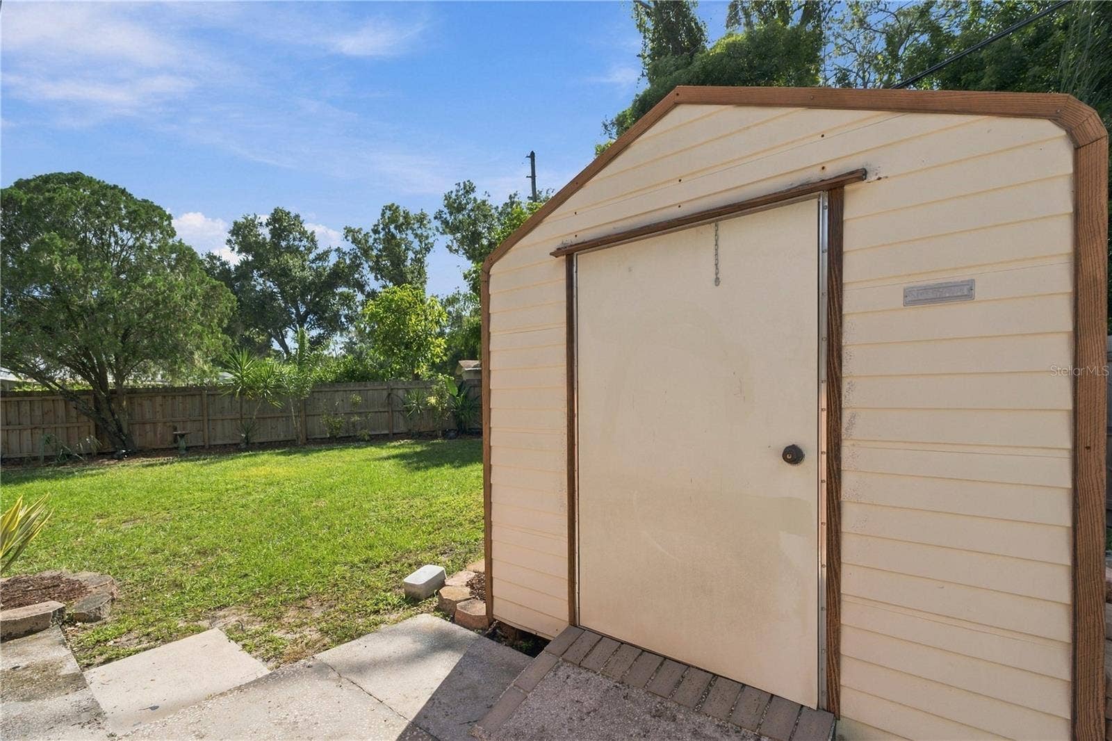 112 PEACOCK CIRCLE, Safety Harbor, FL 34695 73. Elevated Metal Shed on Concrete Pad with Extended Slab for Ease of Use!