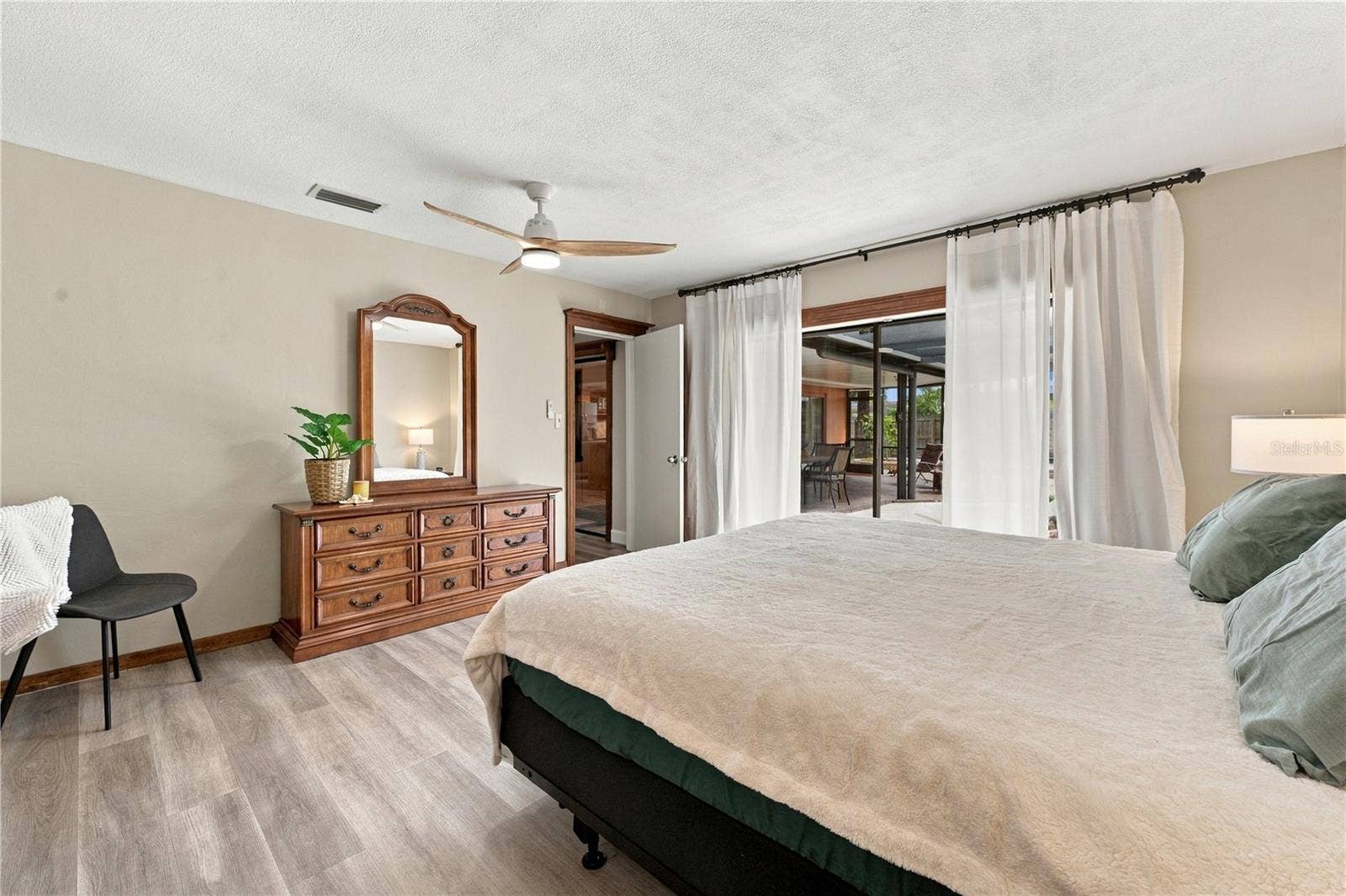 112 PEACOCK CIRCLE, Safety Harbor, FL 34695 58. Owner's Retreat (14.1 x 14.5') Features Oversized Sliders to Lanai.. View of Hot Tub too..