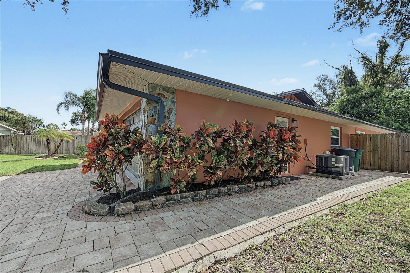 112 PEACOCK CIRCLE, Safety Harbor, FL 34695 40. Extra Wide Paver Sidewalk Wraps Around the Corner to the Garage Entry & Leads to Backyard Fence Gate!