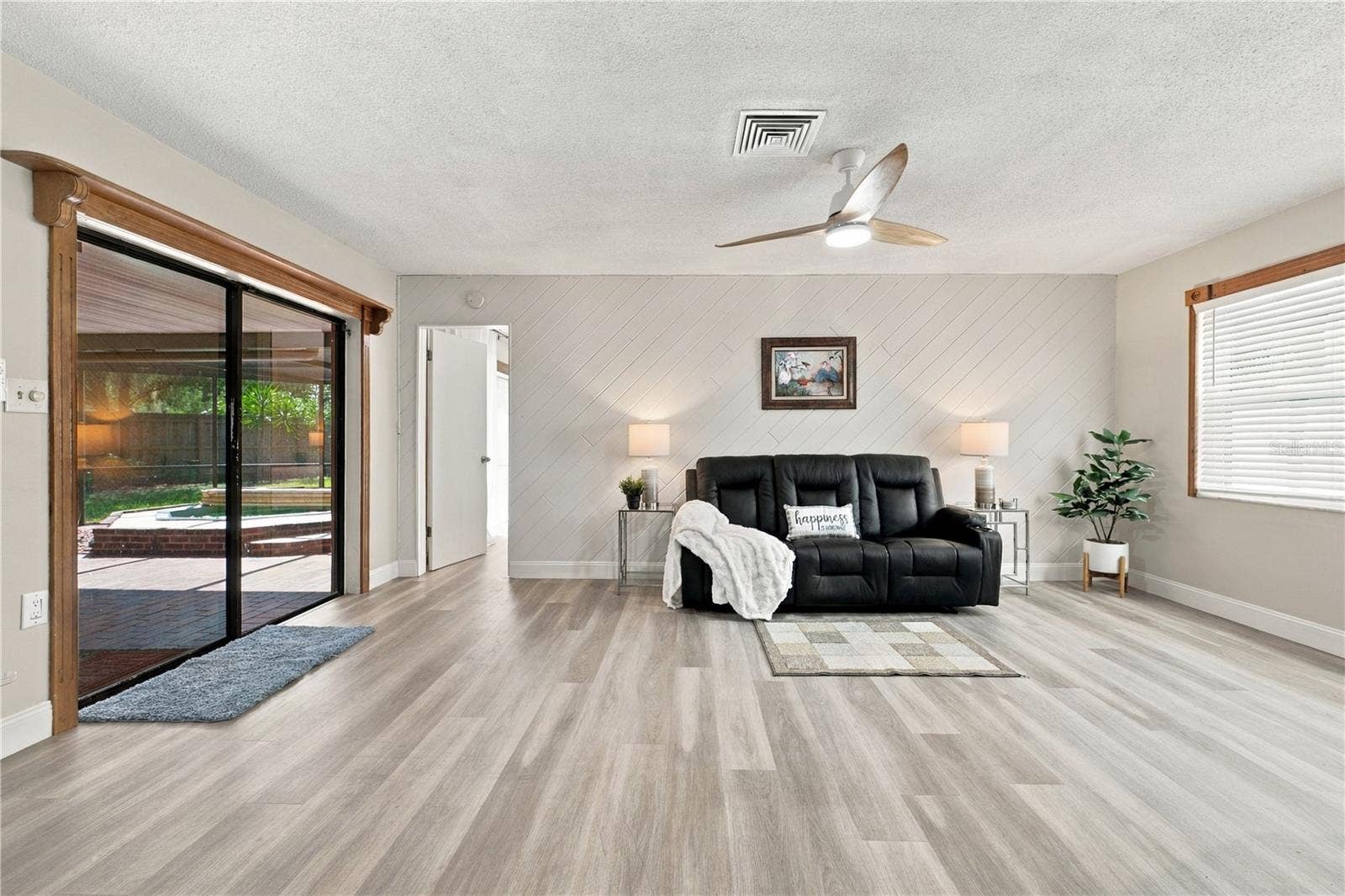 112 PEACOCK CIRCLE, Safety Harbor, FL 34695 20. Family Room (10.10 x 18.9') Features a Wood Accent Wall.. Great Light, a Part of the Great Room!