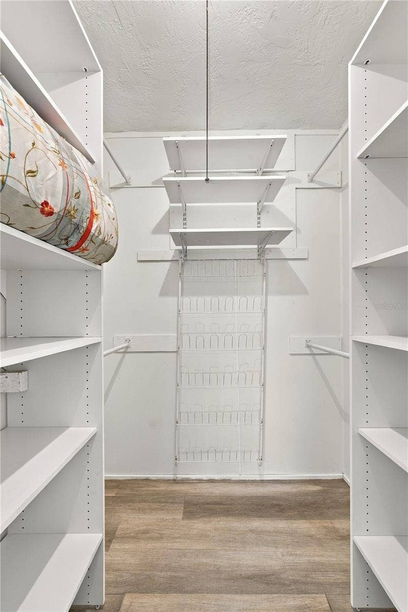 112 PEACOCK CIRCLE, Safety Harbor, FL 34695 24. Owner's Retreat Walk in Closet (4.9 x 5.7') is Built Out for Maximum Storage!!