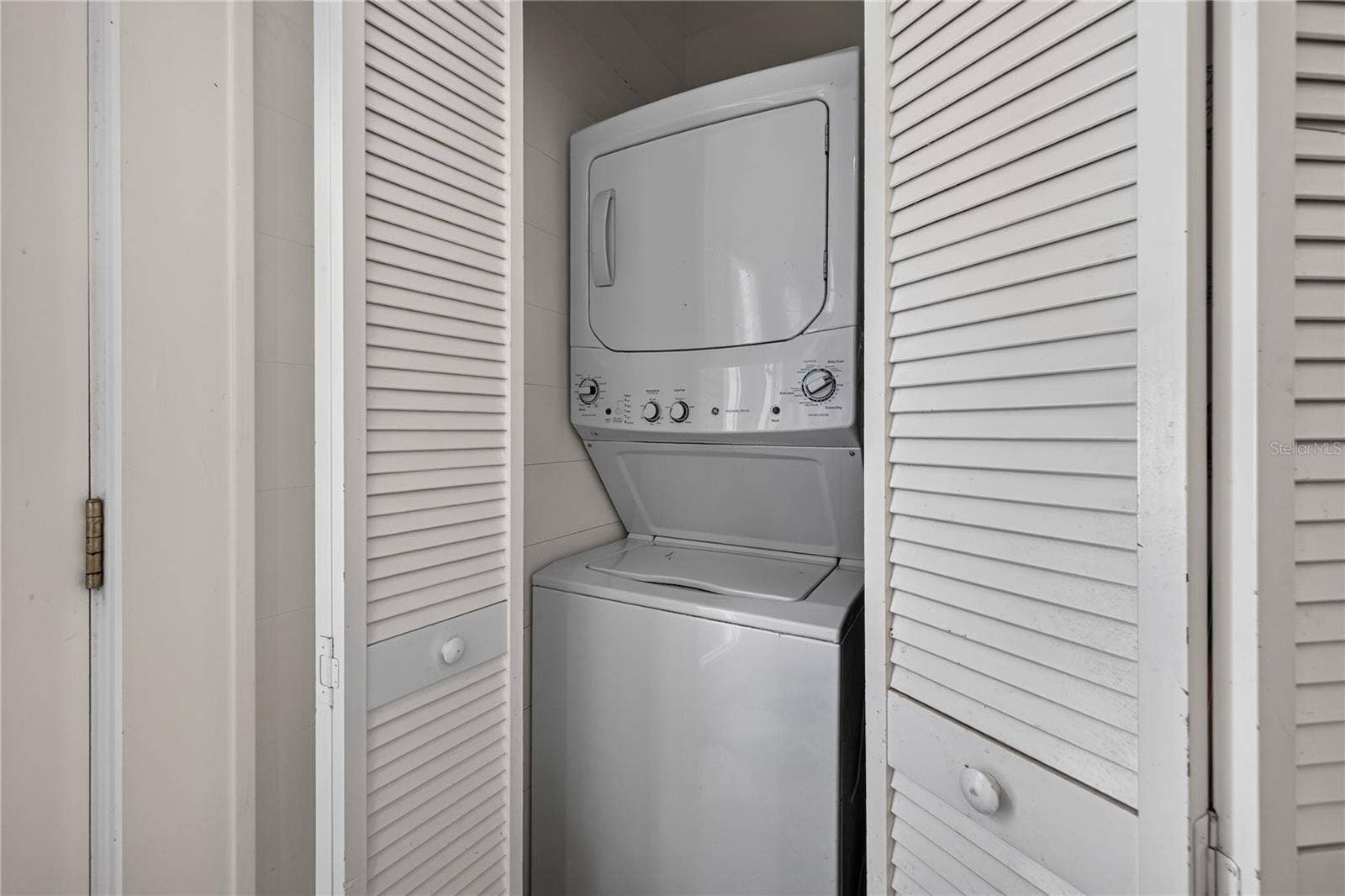 2106 8TH AVENUE W, Bradenton, FL 34205 Stackable washer and dryer in laundry closet in the kitchen