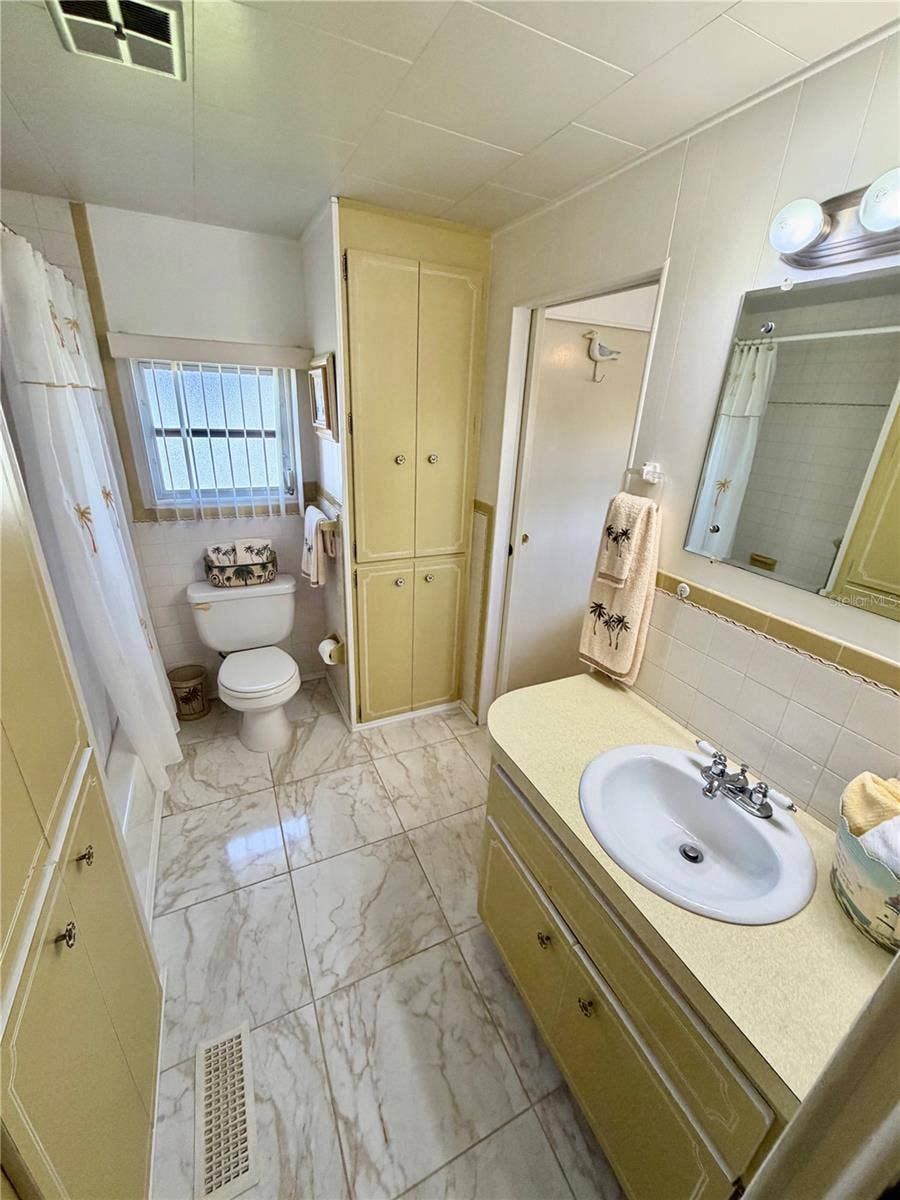 Hall bath entering from the hall. Door ahead leads to the 2nd bedroom