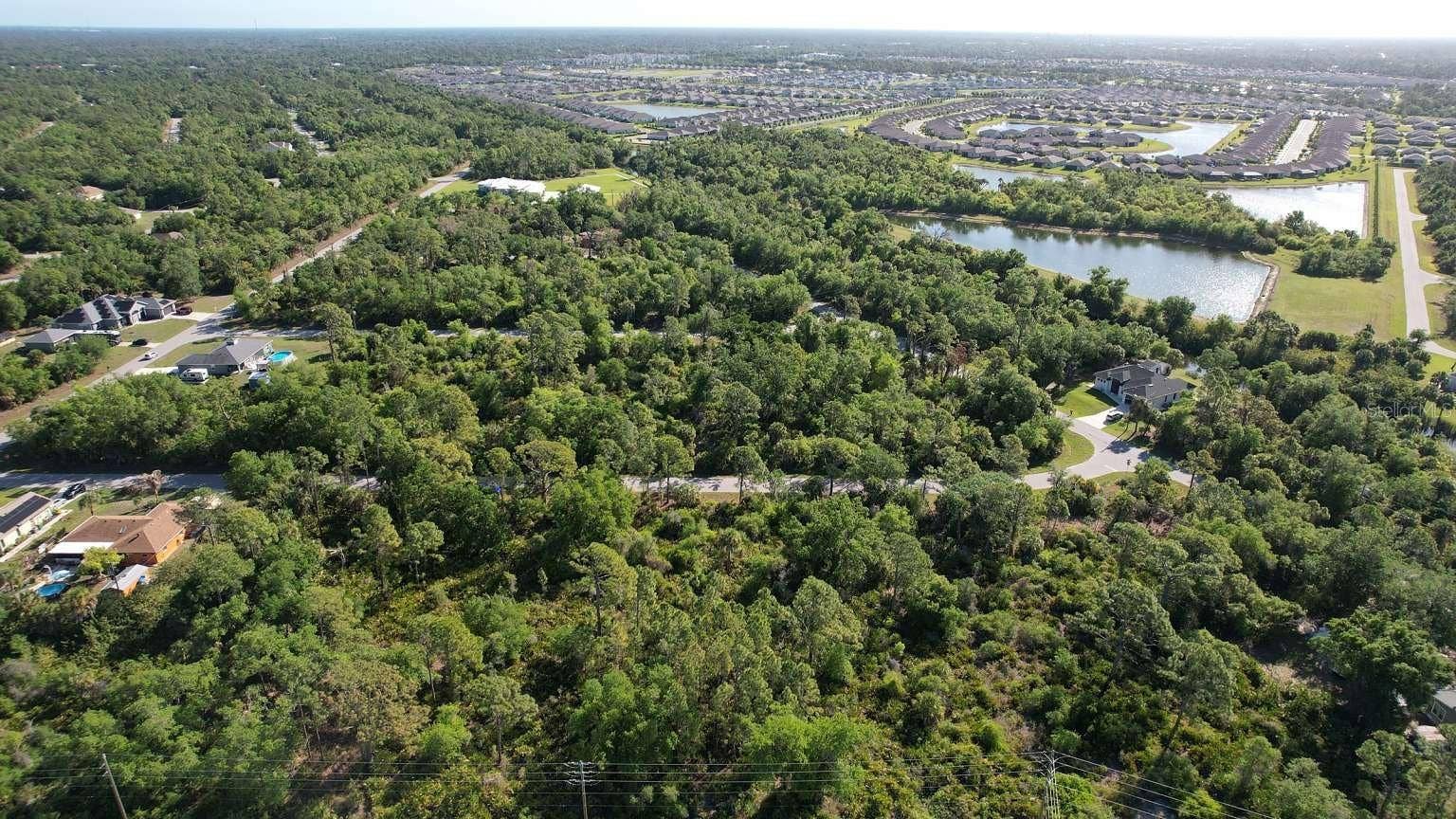 1532 CHAFFIN LANE, Port Charlotte, FL 33953 Aerial view of the surrounding area; nearby water features are not part of this property and do not establish access rights.