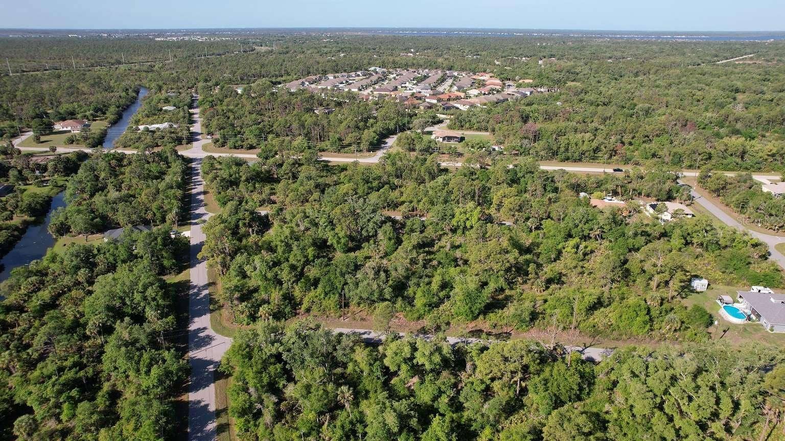 1532 CHAFFIN LANE, Port Charlotte, FL 33953 Aerial view of the surrounding area; nearby water features are not part of this property and do not establish access rights.