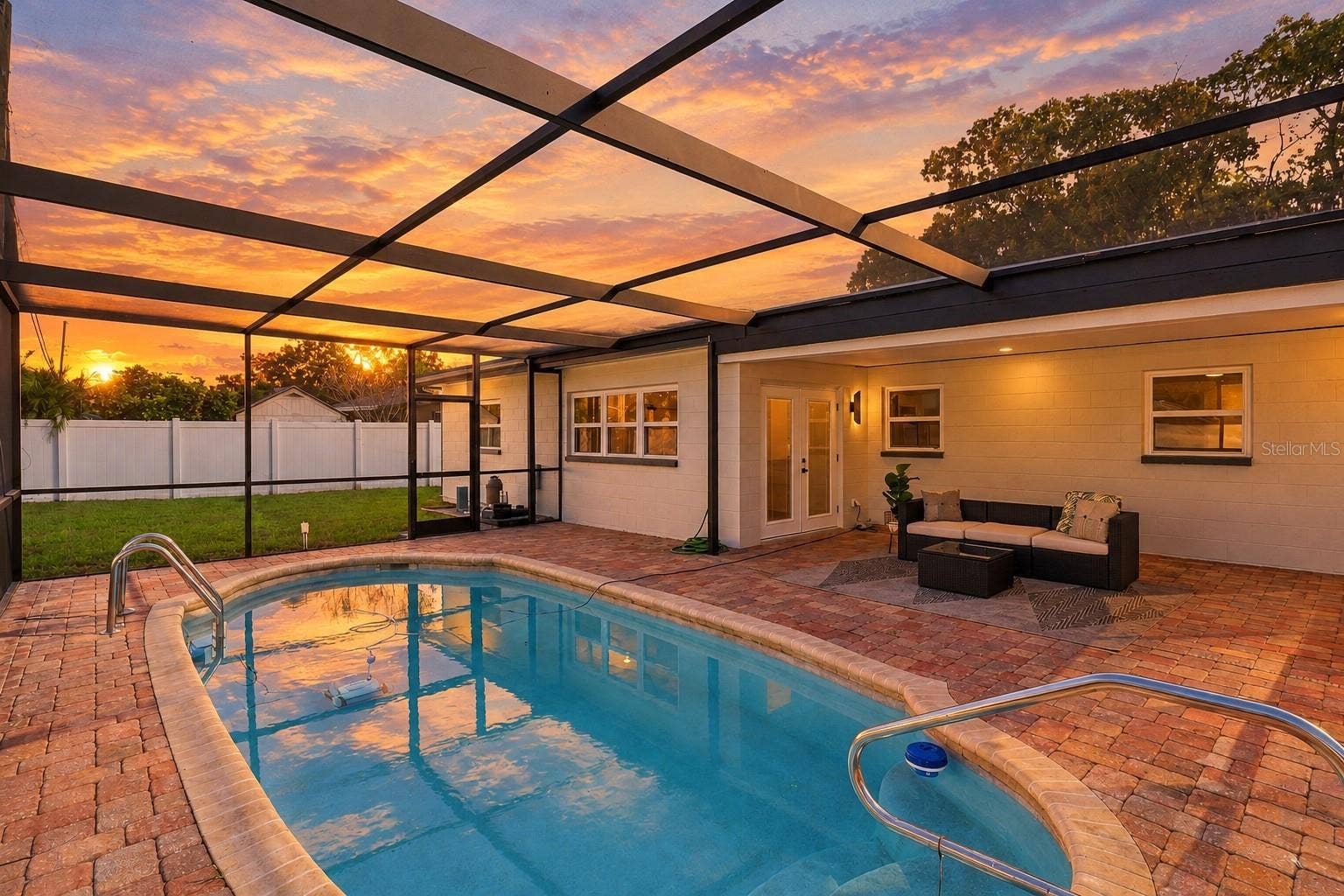 11218 116TH STREET, Seminole, FL 33778 Enjoy beautiful Florida sunsets from your private screened-in pool and spacious paver patio, the perfect setting for relaxing, entertaining, and enjoying outdoor living year-round.