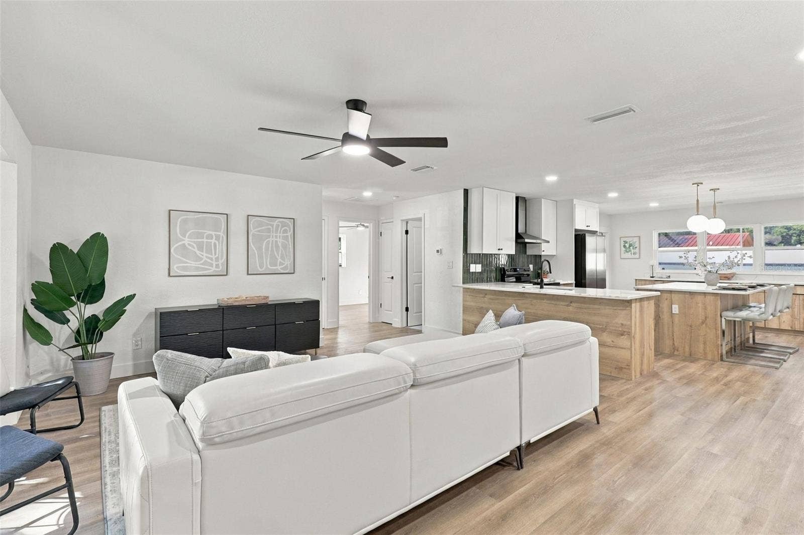 11218 116TH STREET, Seminole, FL 33778 Step inside to a welcoming living room that flows seamlessly into the beautifully updated kitchen, creating an inviting and functional space perfect for everyday living and entertaining.