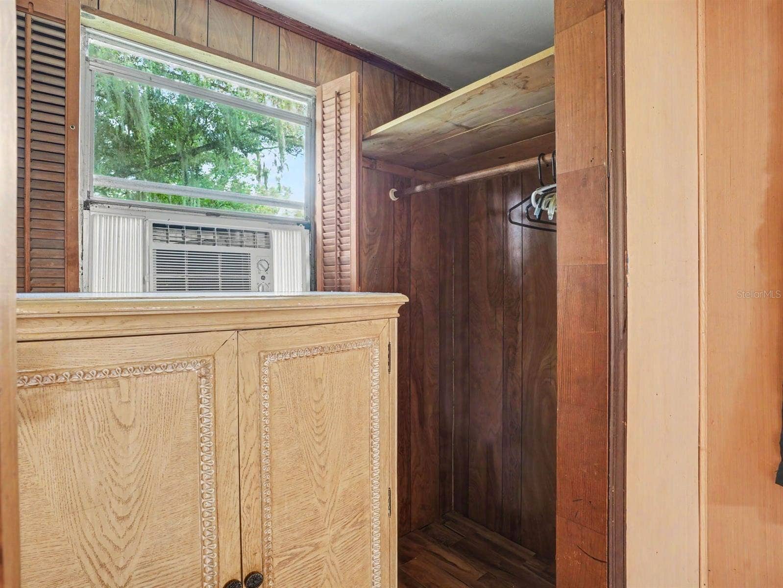 3015 STRAWBERRY LANE, Lakeland, FL 33801 Master Bedroom with Walk-In Closet, Window AC Unit & Relaxing Forest Views