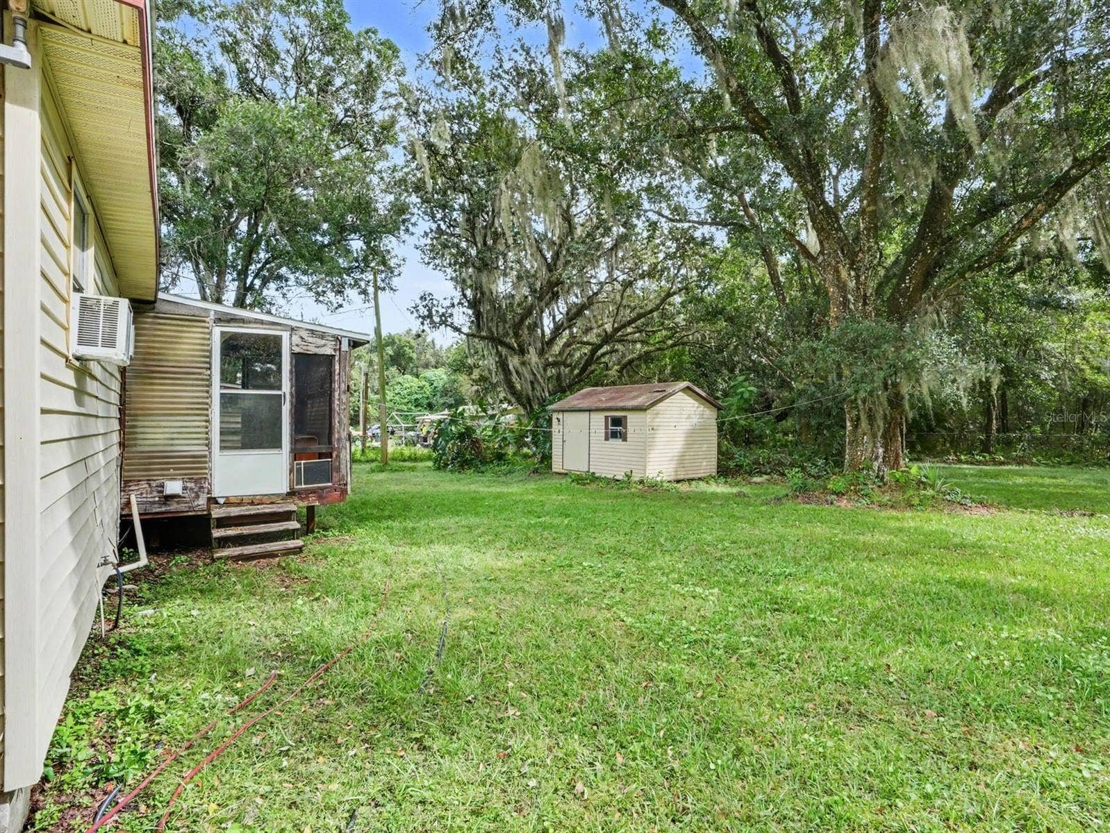 3015 STRAWBERRY LANE, Lakeland, FL 33801 Main residence with adjacent structures amid lush grounds
