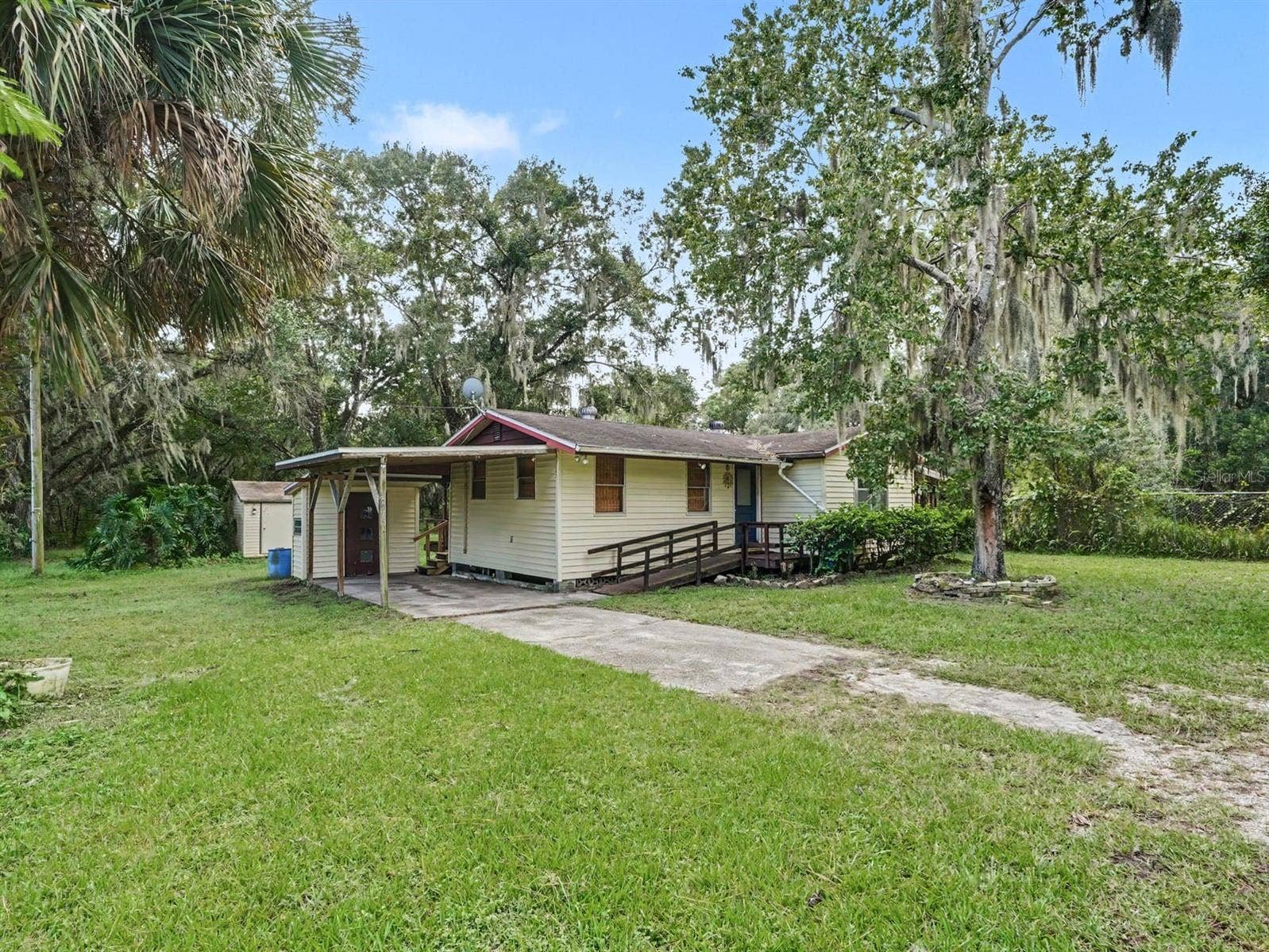 3015 STRAWBERRY LANE, Lakeland, FL 33801 Elevated home with front porch and mature oak canopy