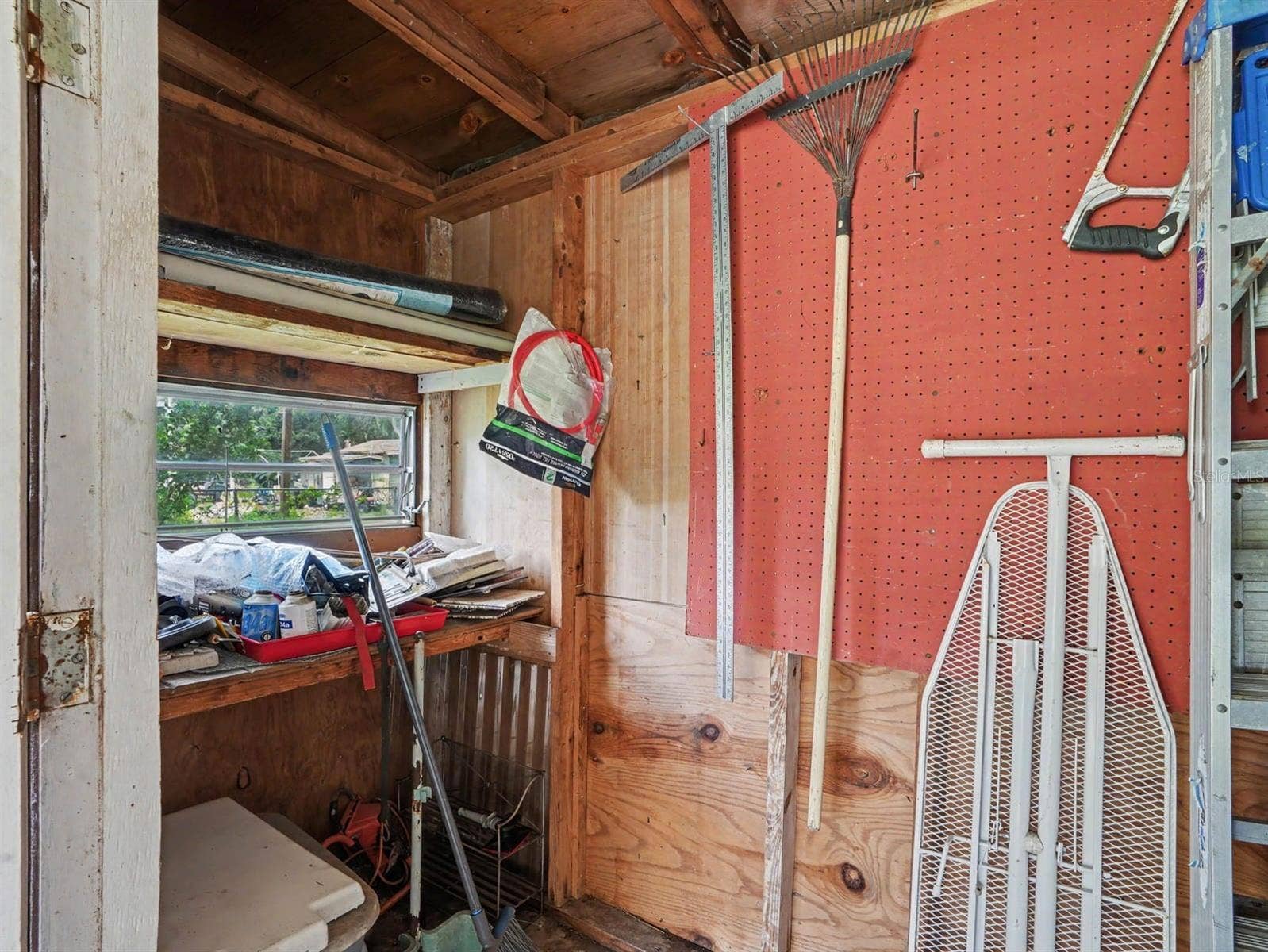 3015 STRAWBERRY LANE, Lakeland, FL 33801 Workshop Storage with Pegboard Organization & Window View
