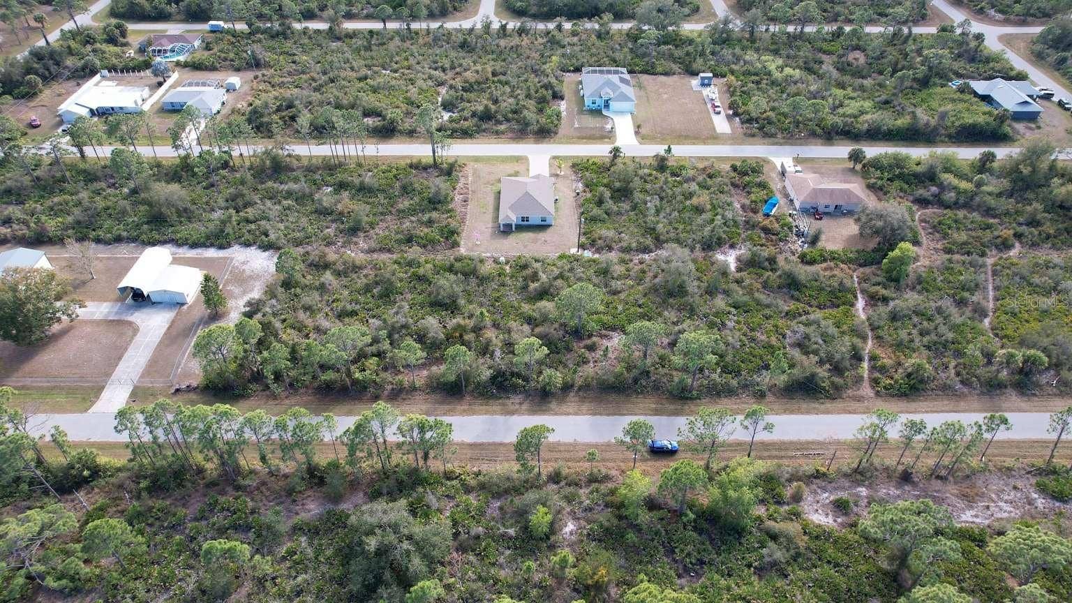 12181 CONROY AVENUE, Port Charlotte, FL 33981 Aerial view of the lot and surrounding neighborhood; neighboring improvements are not included.