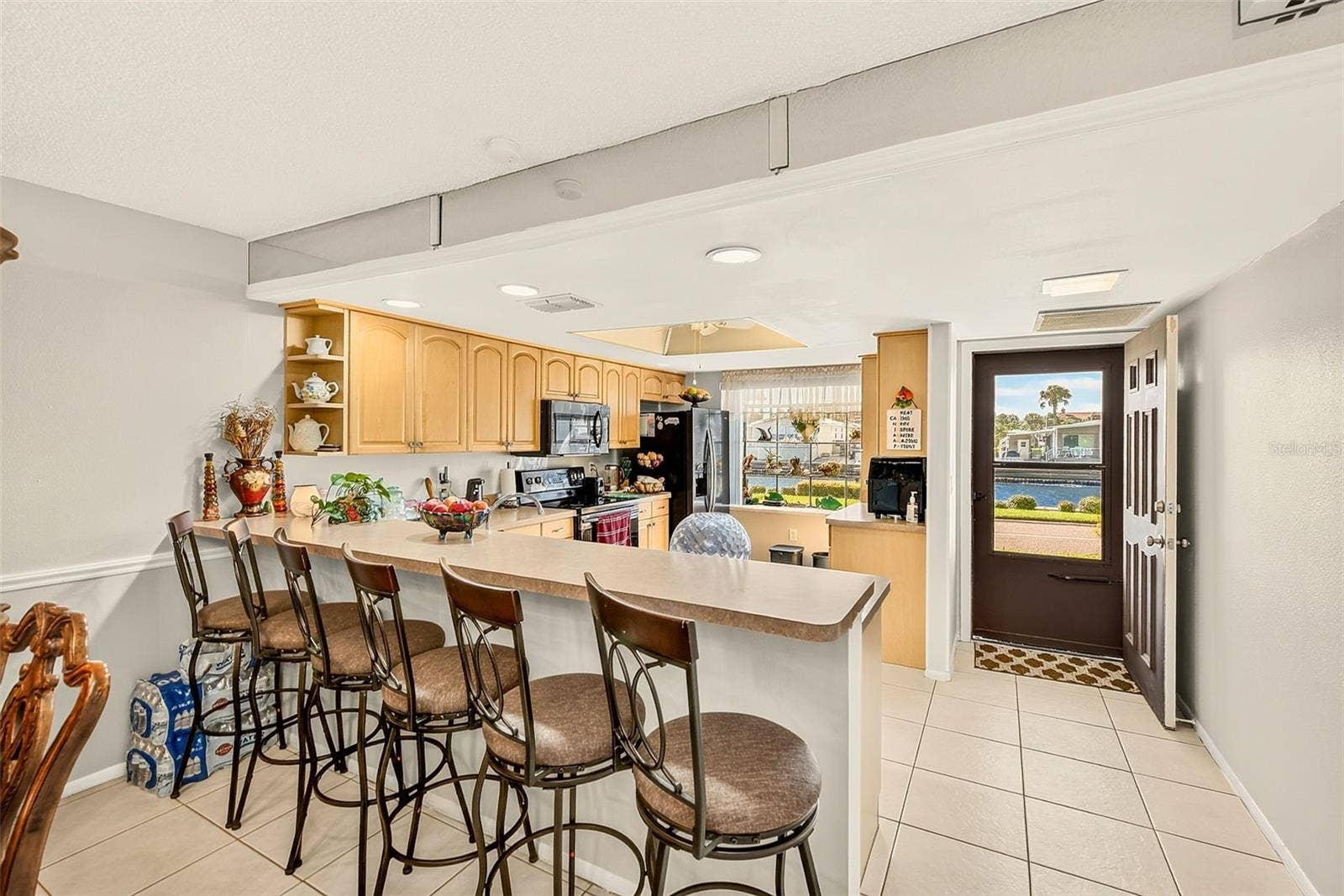 19029 US HIGHWAY 19 N, #21F, Clearwater, FL 33764 View of kitchen with bar stools