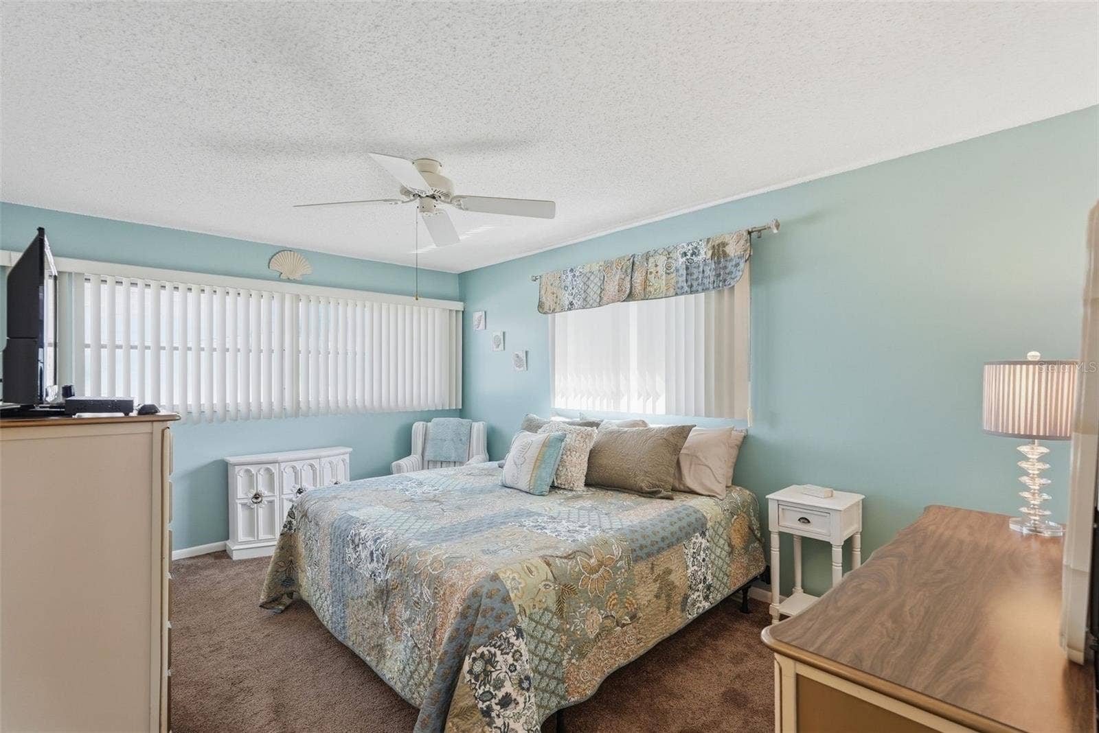 7035 MONTE CARLO N, Pinellas Park, FL 33781 Primary bedroom with ceiling fan, natural light, and room for furnishings.