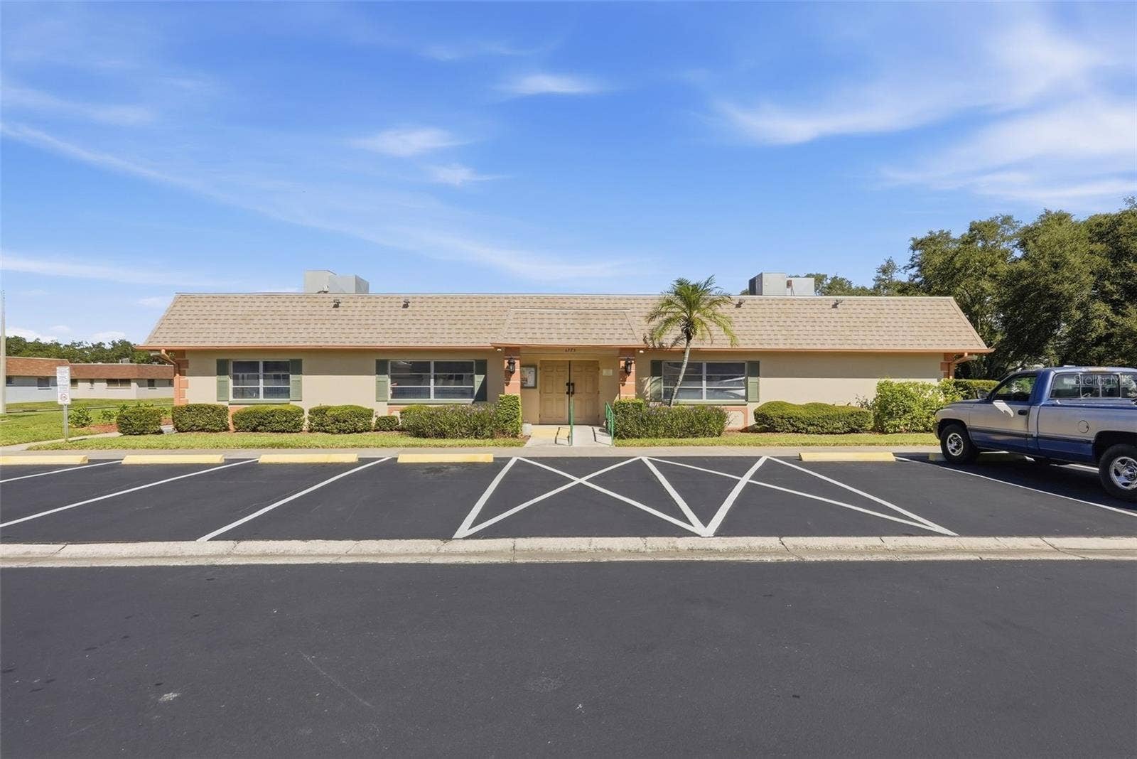 7035 MONTE CARLO N, Pinellas Park, FL 33781 Vendome Village community clubhouse and parking area.